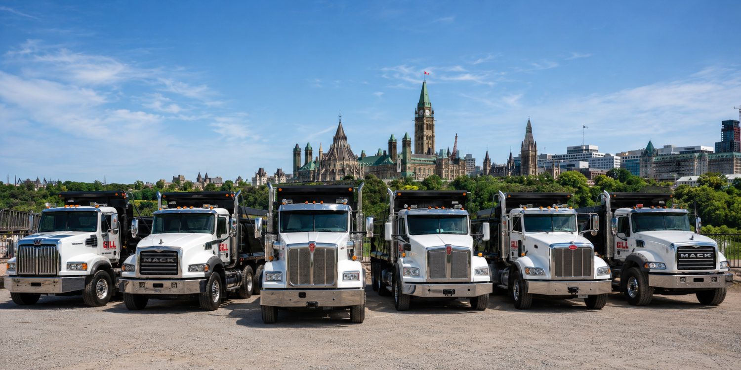 Gill Dumping Solutions Mack, Kenworth and Peterbilt dump truck fleet with the Ottawa Parliament skyline behind
